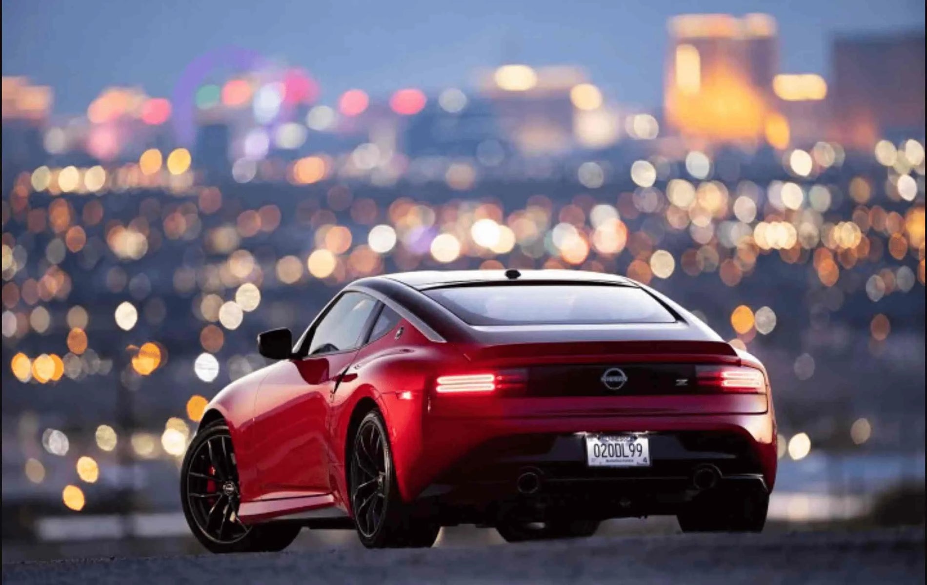 Back_view_of_a_red_car_displaying_its_number_plate_clearly.webp
